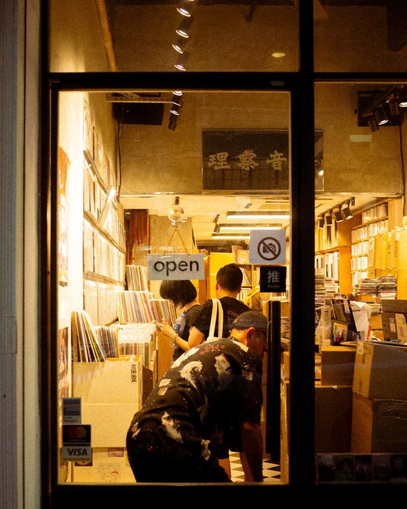 A couple of people that are looking in a window